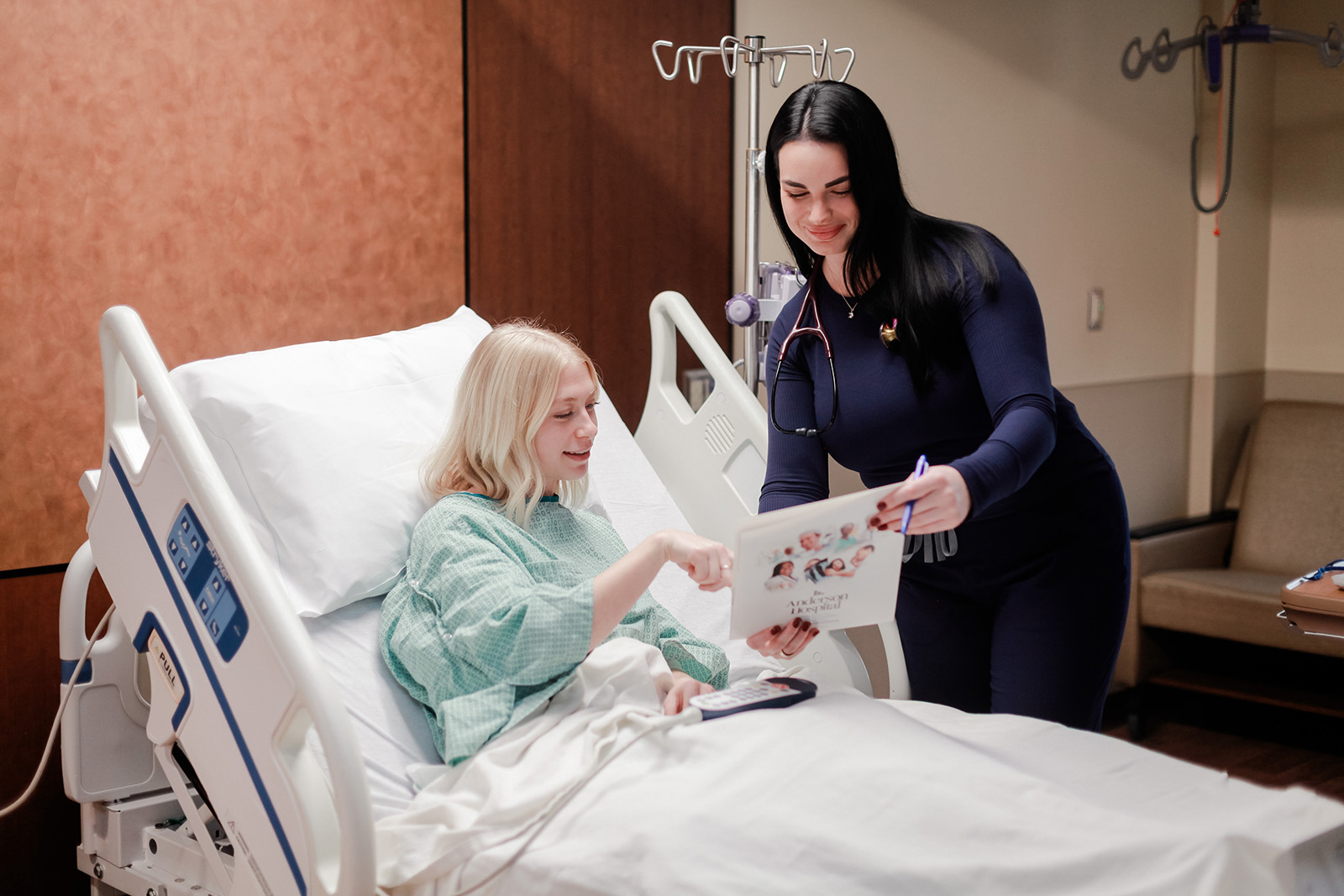 Nurse at Anderson Hospital reviewing treatment brochure with patient