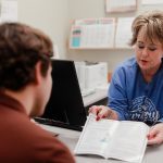 Anderson Hospital staff member reviewing brochure with patient