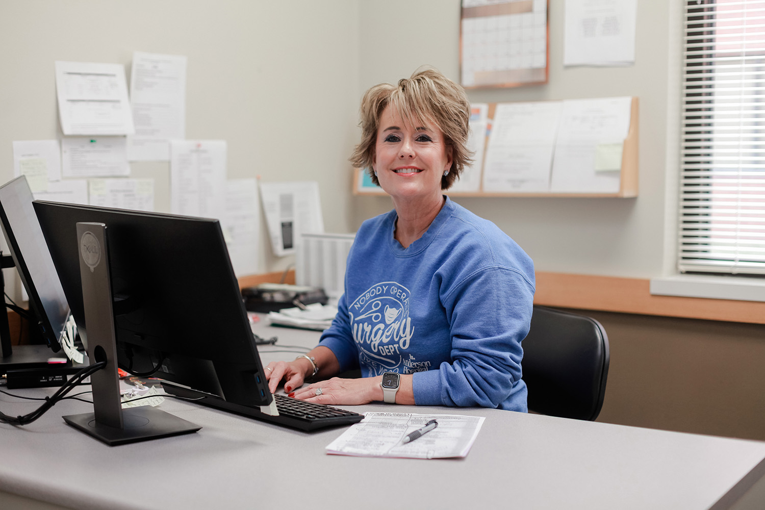 Anderson Hospital staff member smiling at desk in an office