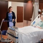 Nurse bringing walker to hospitalized patient